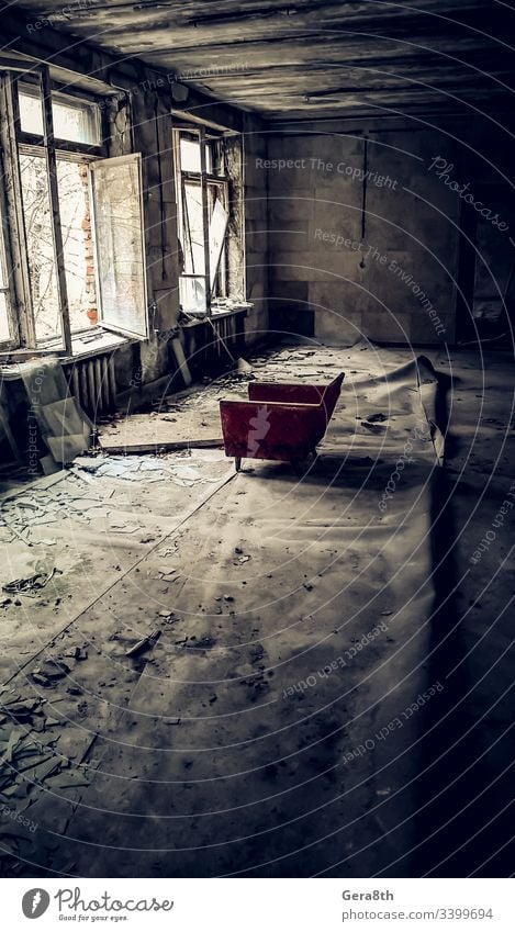 old chair opposite the open window in a ruined abandoned house in Chernobyl Ukraine abandoned city accident bad ecology contamination danger dangerous