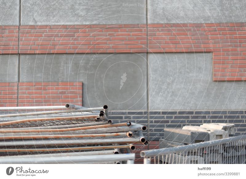 Construction site shut-off in front of concrete wall with partial clinker Barque Fence cordon gray wall Fences Fenced in Metalware Control barrier Safety