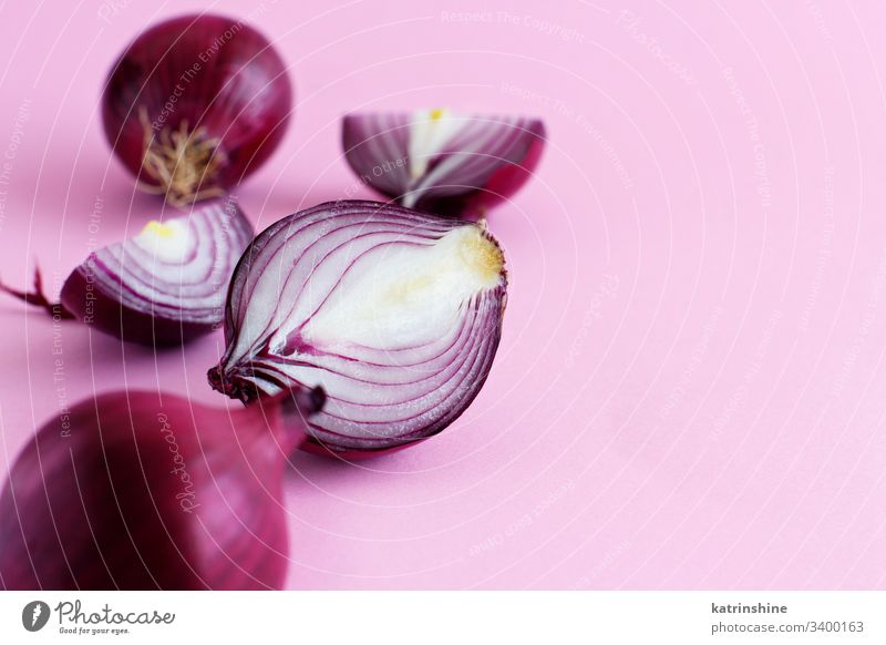 Purple onion on a light pink background purple red sliced half food healthy monochrome raw organic vegetable ingredient vegetarian ripe vitamin natural harvest