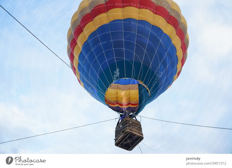 Captive balloon in Aeroestacion Festival in Guadix air hot guadix granada festival aeroestacion flight sky basket fly colorful silk clouds float launch blue