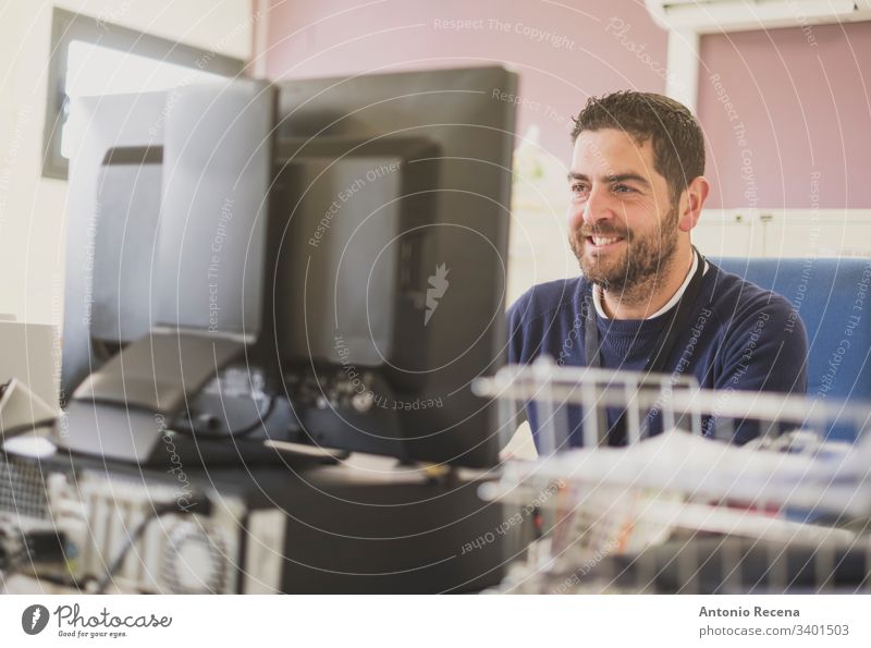 working office worker smiling at pc clerk man file real people latin attractive white collar caucasian adult screen records male 30s bearded computer paperwork