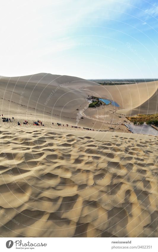 Crescent lake-Yueyaquan amidst Singing or Echoing Sand Mountain-Mingsha Shan. Dunhuang-Gansu-China-0655 several people Chinese tourist visitor