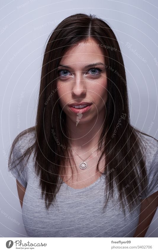 Portrait of a woman touching her hair white background long haired female blue eyes clear eyes portrait happy girl european young caucasian people adult