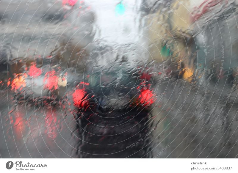 Car rear lights in front of rain-wet windscreen car Rain danger of getting wet Transport Drops of water Water Weather Exterior shot Bad weather brake