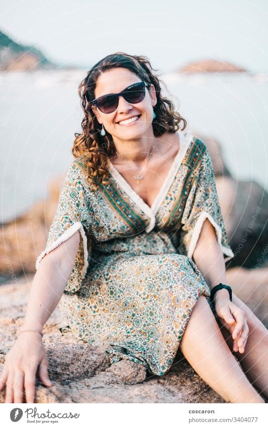 Portrait of a woman with eyeglasses in a rocky coast adult attractive background beach beautiful beauty blue breeze canyon caucasian dress emotion enjoying