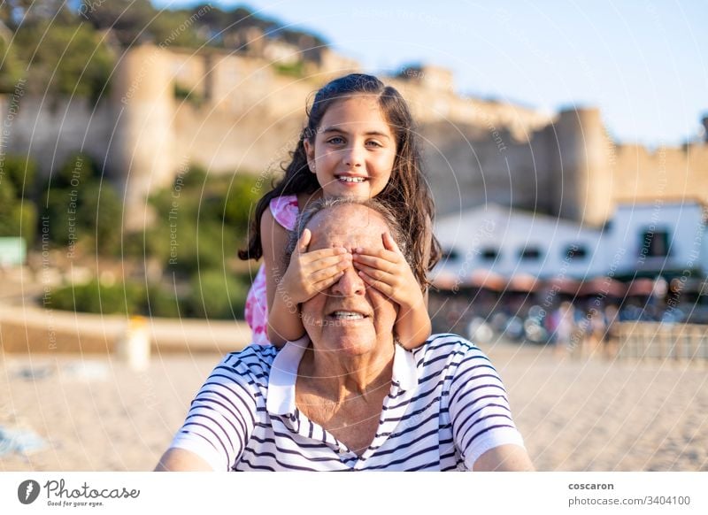 Little girl covering eyes to her grandfather active affection boy cheerful child childhood elderly emotions family fun generation grandad grandchild