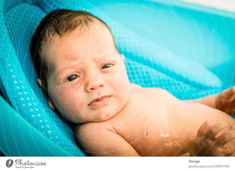 newborn baby at the time of his bath adorable beautiful blanket blue boy care caucasian cheerful child childhood clean closeup comfortable cute emotion