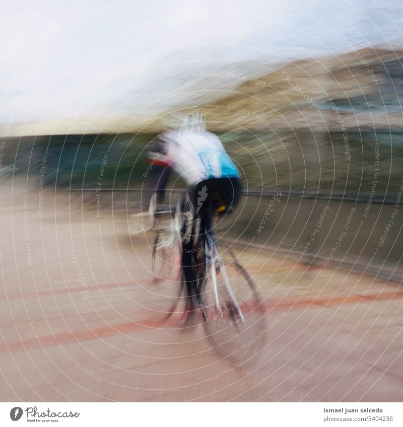 man riding a bike, mode of transport doins exercise in Bilbao city Spain cyclist biker bicycle transportation cycling biking ride speed fast blur blurred motion