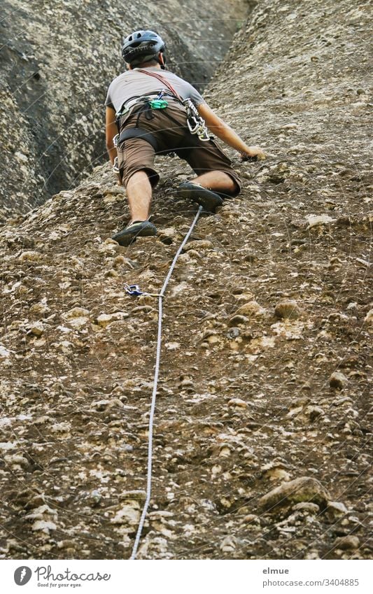 Climber on a rock face climber bouldering Climbing Bouldering Sports Leisure and hobbies Lifestyle Human being Joy Fitness Young man Safety secure sb./sth.