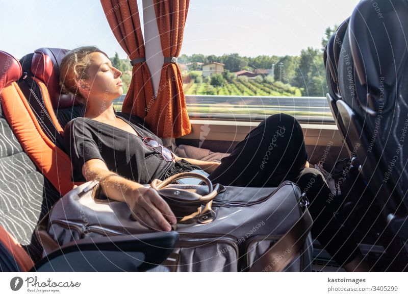 Portrait of tired woman sleeping on bus. passenger female nap commuter girl transportation inside journey people bag person tourism tourist beautiful work