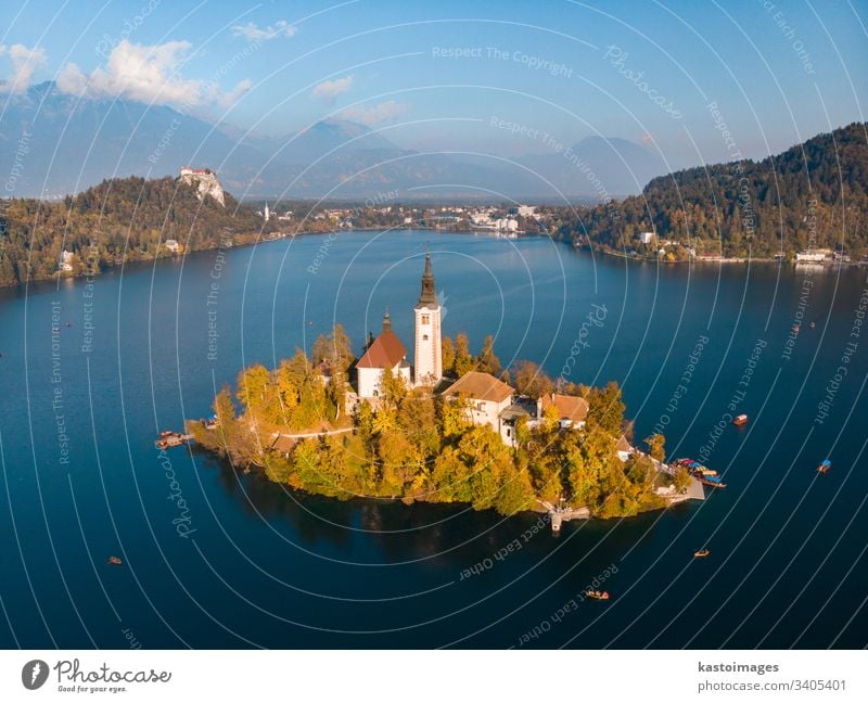 Aerial view of Bled island on lake Bled, and Bled castle and mountains in background, Slovenia. slovenia bled scenic landmark church julian water scenery europe