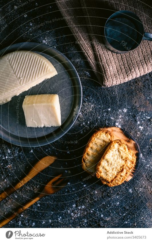 Cheese and toasts on messy table cheese kitchen food utensil napkin rustic cuisine tasty meal homemade gourmet fresh delicious nutrition culinary organic