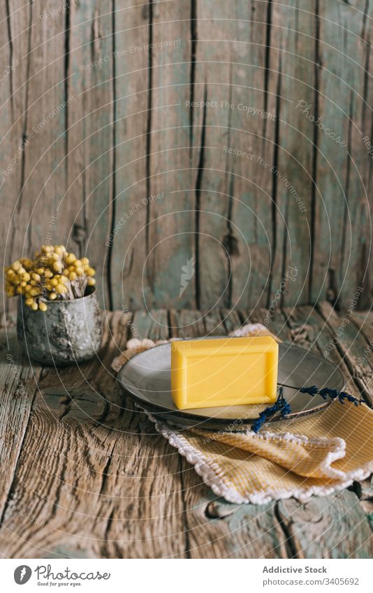 Soap and natural ingredients on table soap flower wooden rustic shabby organic retro napkin piece plate cup lumber timber weathered homemade rough design plant