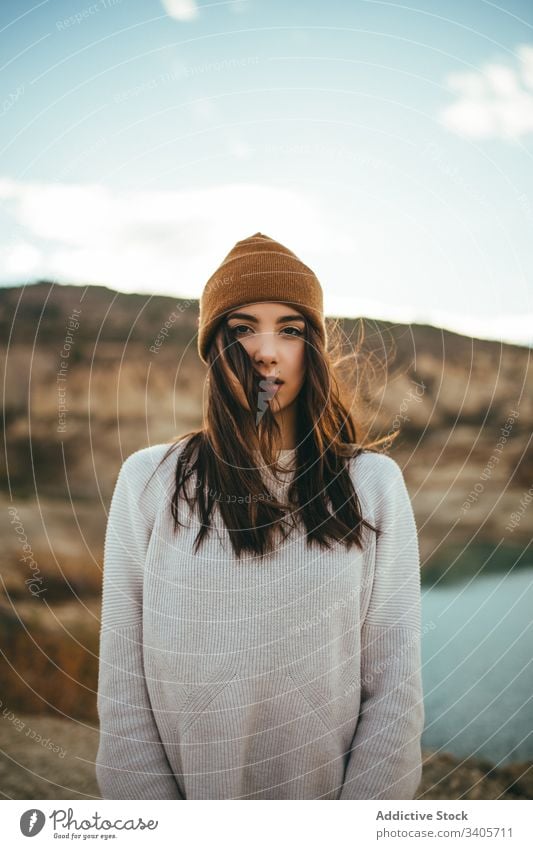 Young woman in countryside in autumn tourist enjoy journey lake nature female vacation travel freedom romantic carefree destination rural environment explore