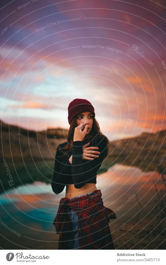 Dreamy young female model on shore in sunset woman coast colorful sundown countryside nature evening feminine romantic sensual lake hiker sensitive temptation