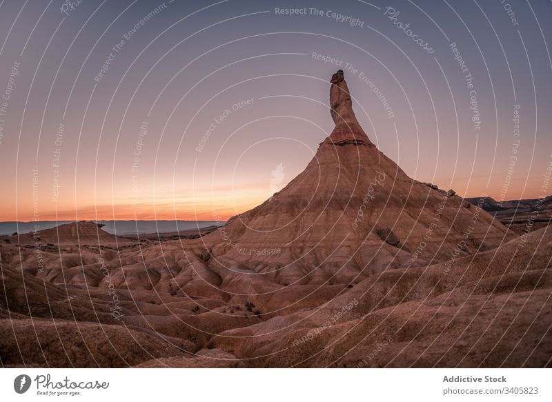 Mountain peak against sunset sky mountain desert dry terrain stone landscape evening bardenas reales navarre spain nature scenic destination hill dusk rock