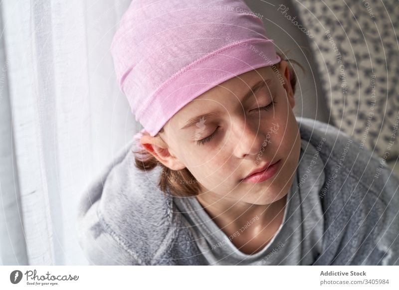 Adorable sick little boy in bandana in room cancer fight child small patient courageous disease male against awareness recovery strength kid willpower hope