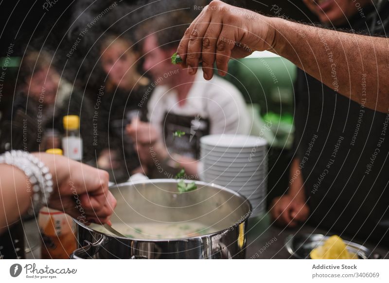 Crop people cooking dish together lesson restaurant parsley green add ingredient food prepare kitchen cuisine meal chef professional tasty delicious yummy