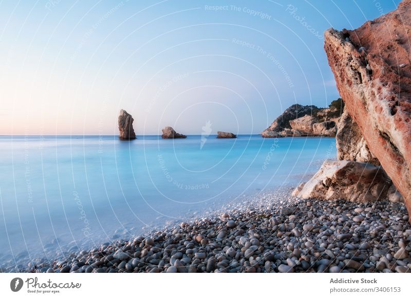 Rocky shore and peaceful sea during sunset rock sky cloudless landscape niu de s'aguila ibiza spain water nature ocean coast calm scenic picturesque cliff