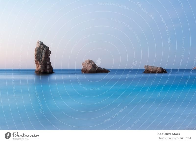 Rocky shore and peaceful sea during sunset stones rock sky cloudless landscape niu de s'aguila ibiza spain water nature ocean coast calm scenic picturesque