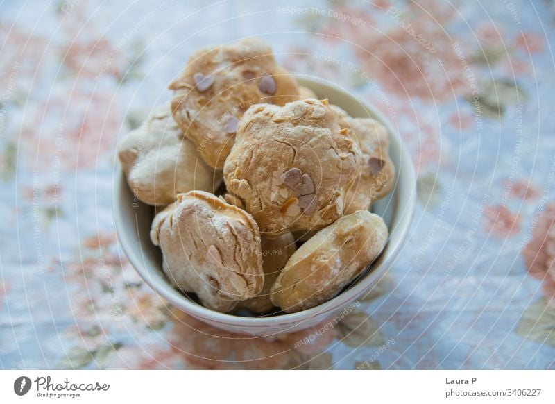 Close up of home-made baked sweets in a white bowl on a shabby chic table cloth close up delicious baking brown natural food raw healthy snack dessert tasty