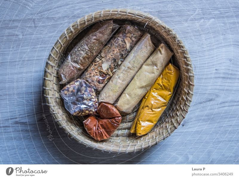 Top view of a round braided basket with condiments top view view from above seen from above top viewturmeric yellow Cooking Rustic food and drink Cinnamon