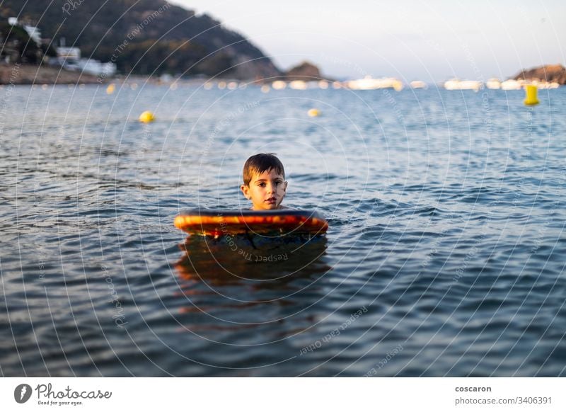 Little child with a bodysurf on the sea active activity beach beautiful beauty blue board boarding bodyboard bodyboarding bodysurfing cheerful childhood coast