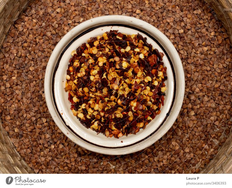 Close up of condiments in a round bowl - chilli and buckwheat close up spices herbs rustic delicious food nutrition vegetable raw diet healthy Vegan diet