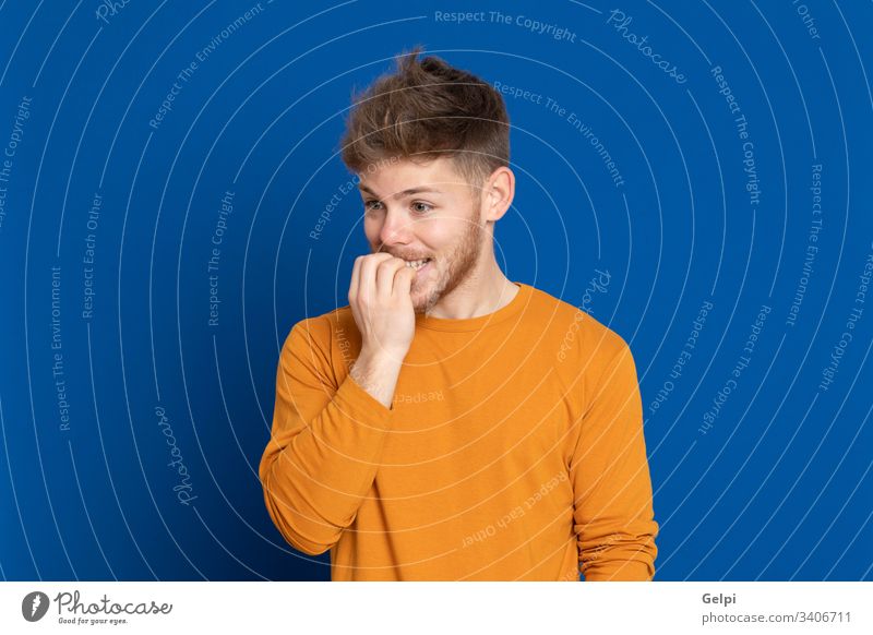 Attractive young man with yellow T-shirt Guy Blue Yellow Happy Meditative nervous excited Pensive Think fancy imagination Idea solution Doubt doubtfully Smart