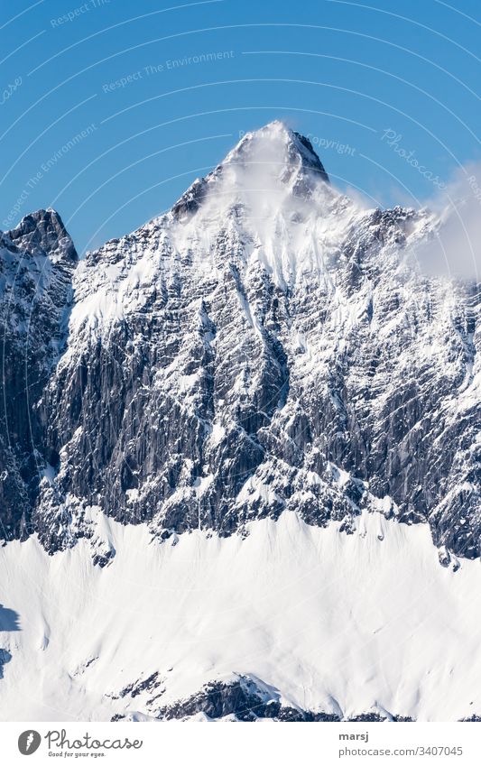 Mighty Mitterspitz in a fine veil of mist Deep depth of field Exterior shot Colour photo Fantastic Snowcapped peak Peak Dachstein mountains Mountain Alps Rock