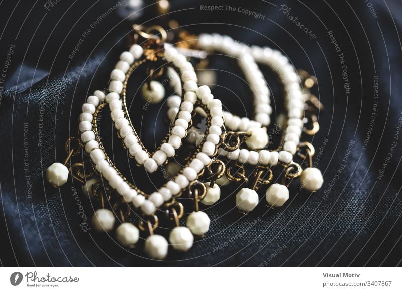 Close-up of a couple ethnic style earrings with white beads abstract photography art art and craft beautiful boho boho style chic close up close-up