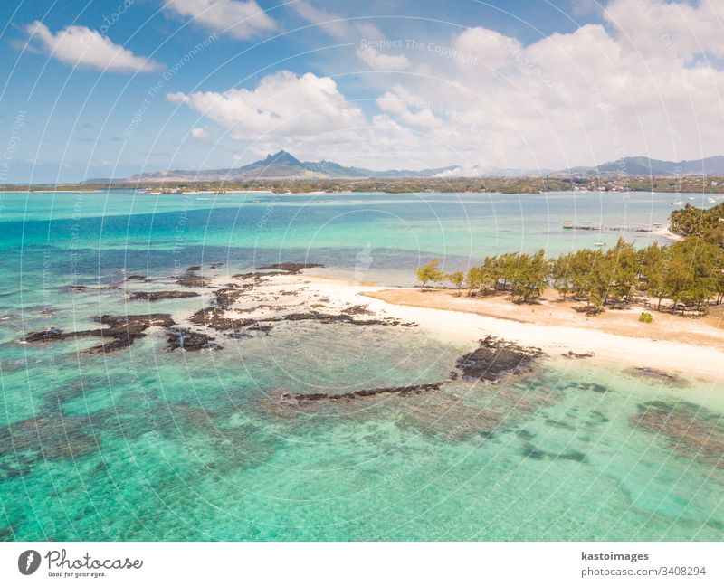 Aerial view of beautiful tropical beach with turquoise sea. Tropical vacation paradise destination of D'eau Douce and Ile aux Cerfs Mauritius Trou Deau Douce