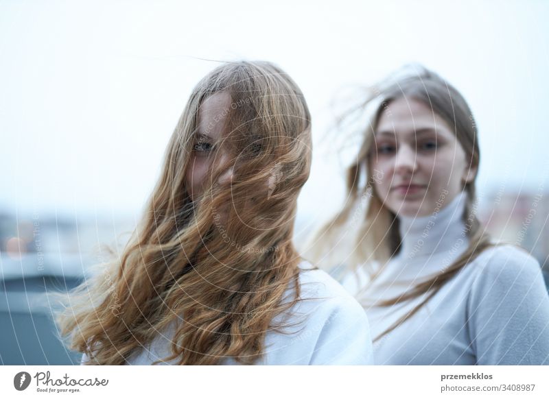 Two young woman looking at camera outdoors. Portrait of teenage girls portrait beautiful pretty joy stylish cute female smile youth lifestyle fashion trendy