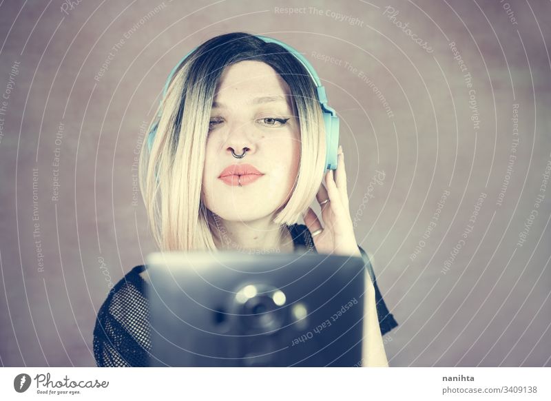 Young modern woman listening to music technology enjoy fresh headphones piercing headset cool freshness youth hobby leisure time portrait portraiture people