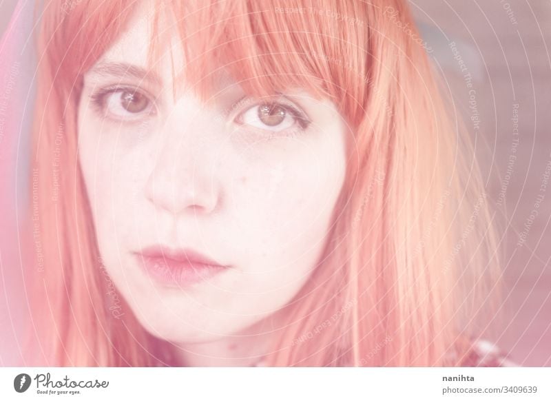 Romantic and dreamy portrait of a redhead woman young blur blurry effect creative creativity pastel tones pretty face mood moody daydream daydreamer art