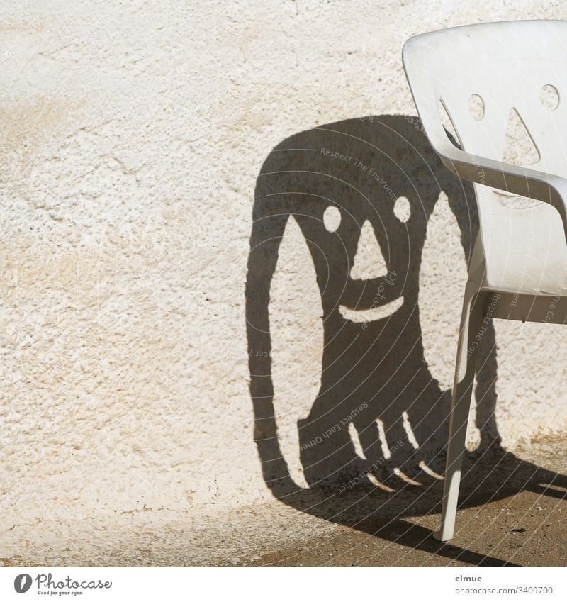 funny shadow of a plastic chair Chair Plastic chair Camping chair Shadow Laughter Face Wall (barrier) Happiness smile Furniture Deserted Exterior shot