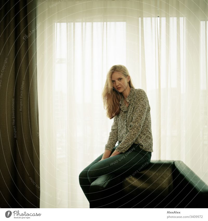 Portrait of a young woman on an armchair in front of the window Woman Girl Blonde Beautiful youthful Slim daintily Elegant Lifestyle dwell Flat (apartment)