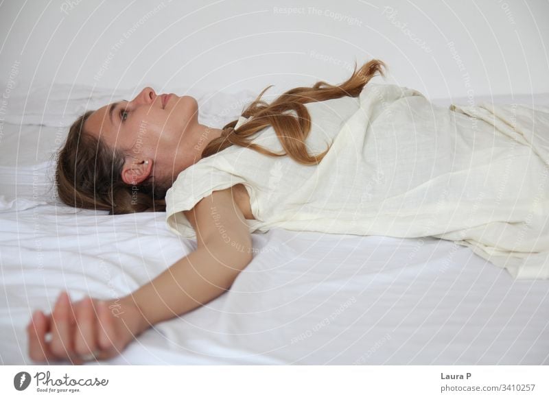 Young smiling woman with braided hair, dressed in white young face natural look close up portrait green eyes peaceful nice beautiful beauty fresh silent single