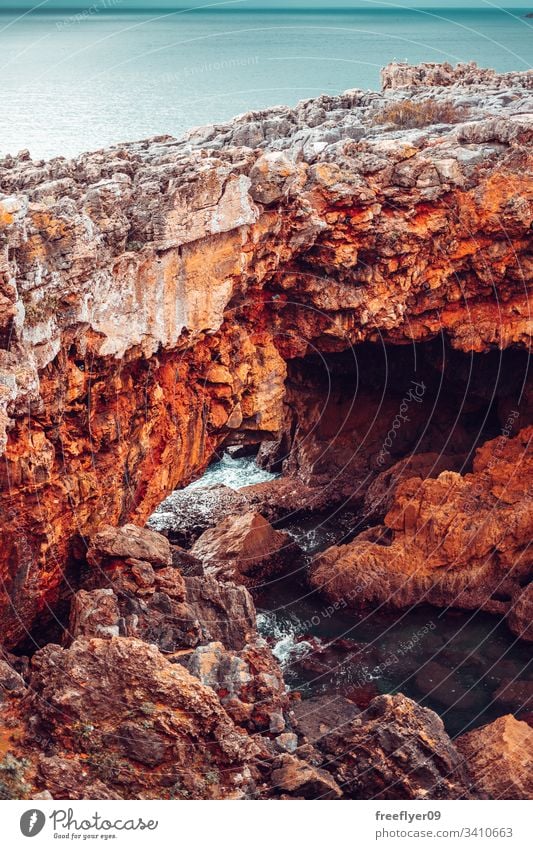 Stone bridge made of cliffs near the ocean tourism sea galicia portugal rock landscape vertical atlantic touristic tour tourism stone landmark sun coast water