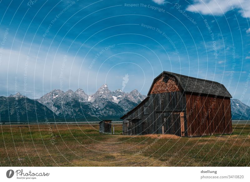 Wooden hut in the foreground in front of snow-covered mountains in good weather Hut Foreground Cloudless sky beautiful weather sunshine Snowcapped peak