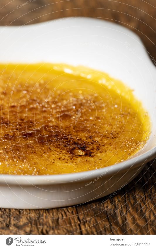 Cream brulee on dark wood catalana Dark Wood Temptation biscuits European Egg crema Gourmet Sugar au gratin Caramel Spanish Crisp Catalonia Vanilla pod French