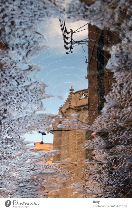 Part of a church reflected in a puddle reflection Puddle Church Building Part of a building Masonry Crucifix Old Historic Stone off Water Sky surreal sunshine