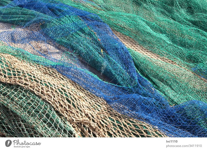 coloured fishing nets are lying on the quay for repair Majorca Fishing net Blue Green Beige Repair Harbour Craft (trade) seafaring Fisherman Profession meshes