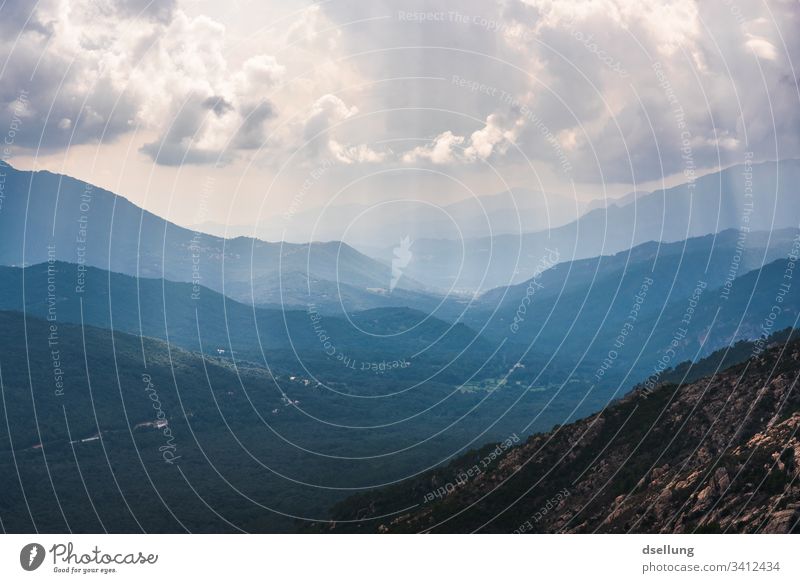 View of several levels of mountains with sunrays in cloudy weather Beautiful weather Expedition Climate change Environment Blue Weather Panorama (View) Light