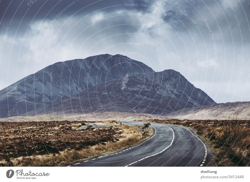 Simple road in Ireland with mountain in the background Panorama (View) Deep depth of field Day Copy Space bottom Deserted Exterior shot Colour photo