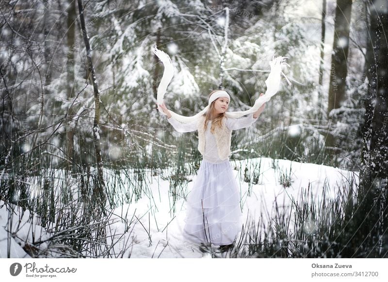 A 7 year old girl walks in the forest. Concept of the seasons, a winter fairy tale. Snow, trees. baby background beautiful beauty blue boots child childhood