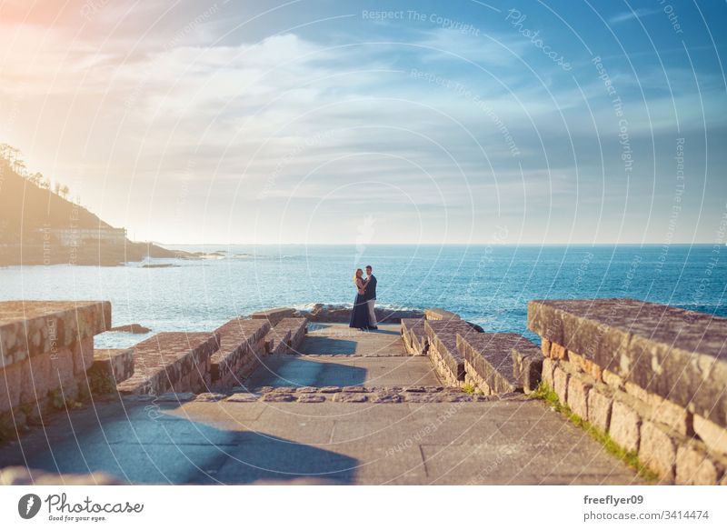 Young couple enjoying time together near the sea love wedding nature ocean baiona vigo galicia plants romantic sunset horizon landscape seascape destination