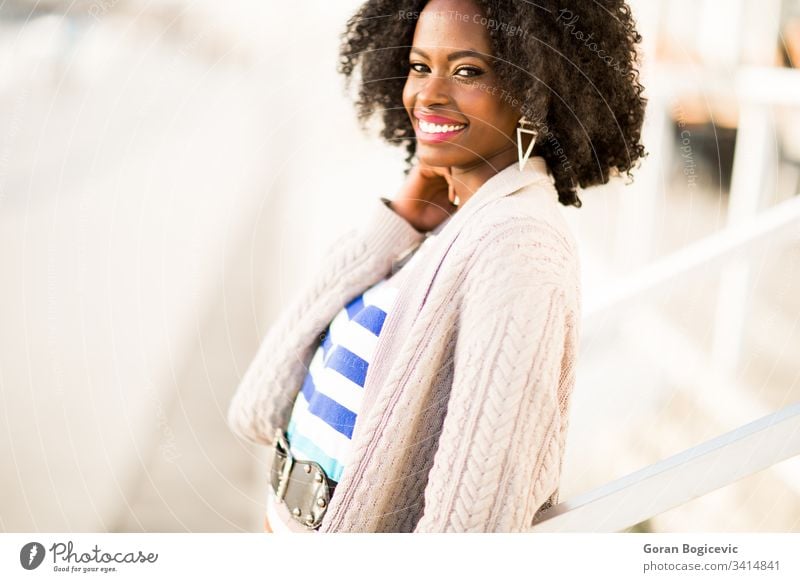 Young black woman on the street ethnicity calm day adult sunny female afro girl outdoors american charming leisure attractive curly relaxing cute modern