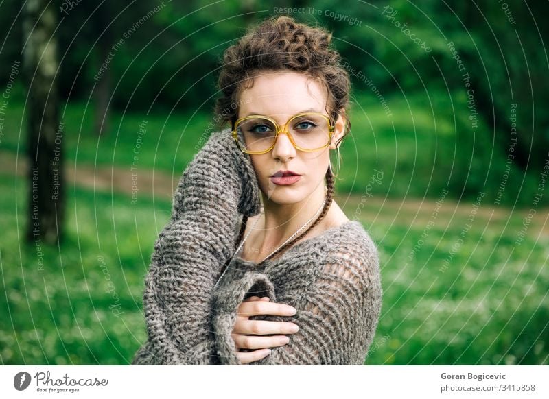 Pretty young woman with eyeglasses in the forest face pretty casual female girl adult attractive portrait beautiful caucasian natural cute park outside person