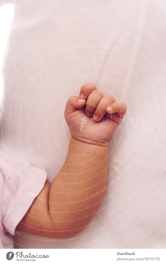 Hand of a baby bed hand sleeping white cute face child small little happy beautiful beauty newborn view top portrait smile cot kid sweet boy girl toddler